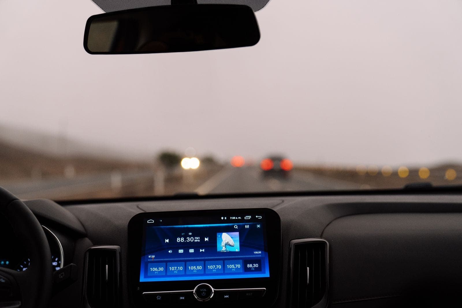 Dashboard and windshield view of a highway, where the lane camera reads the road