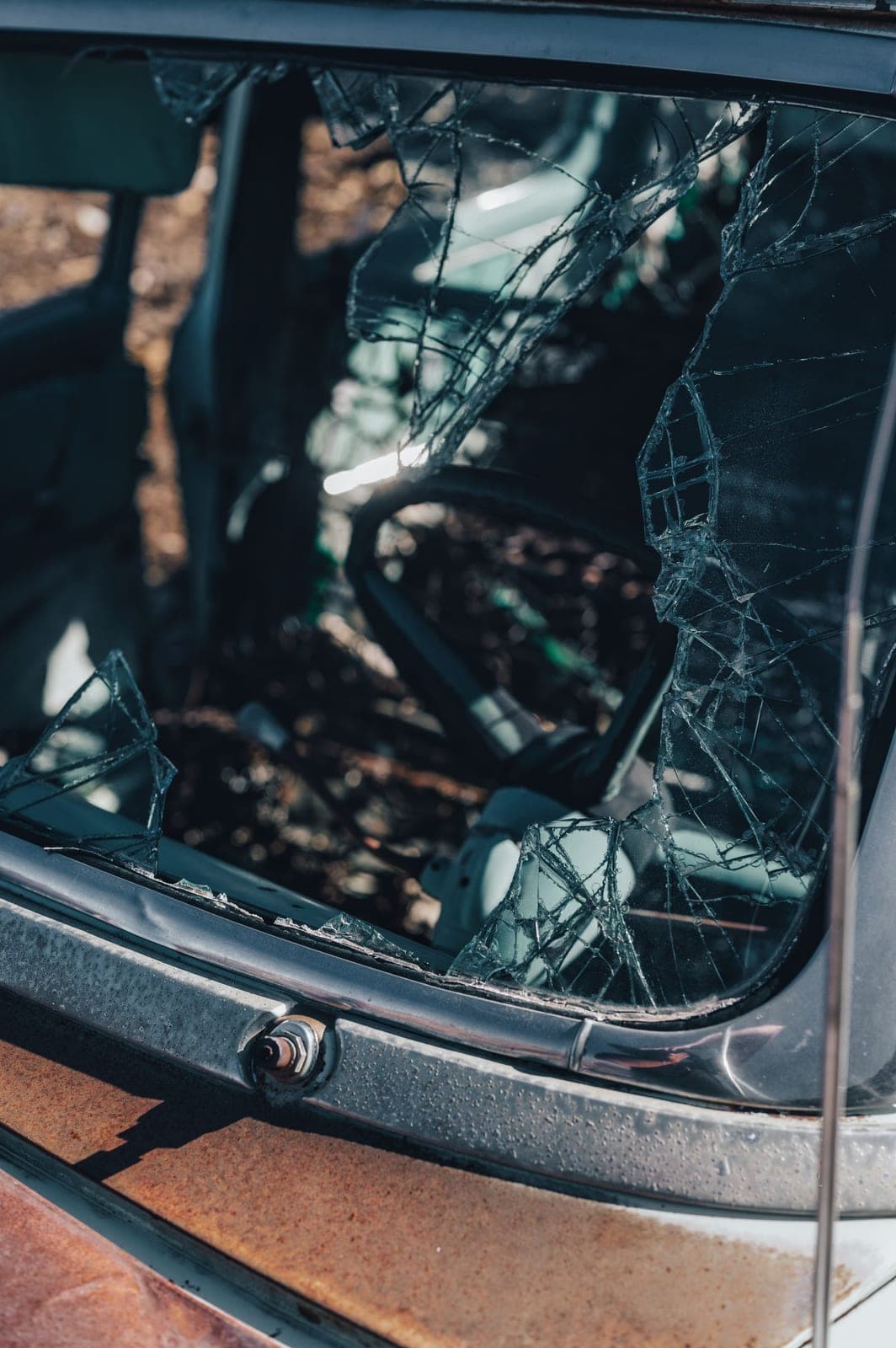 Shattered tempered side window glass in a car door