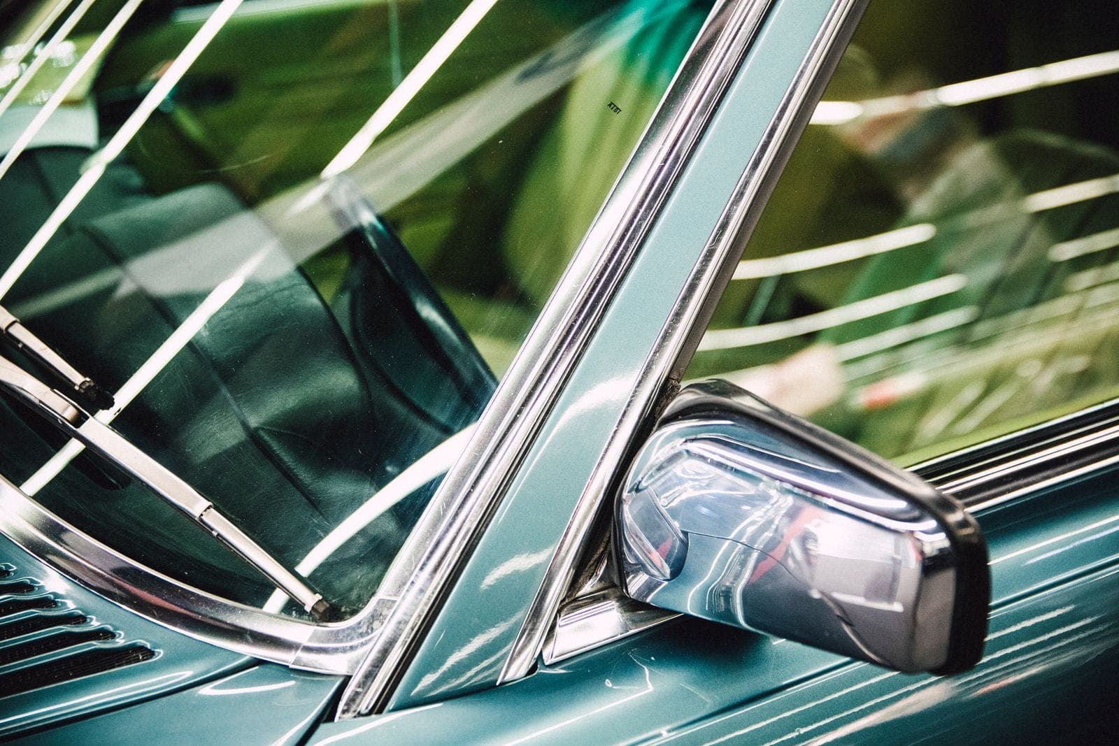 Chrome window trim and side mirror on a car door